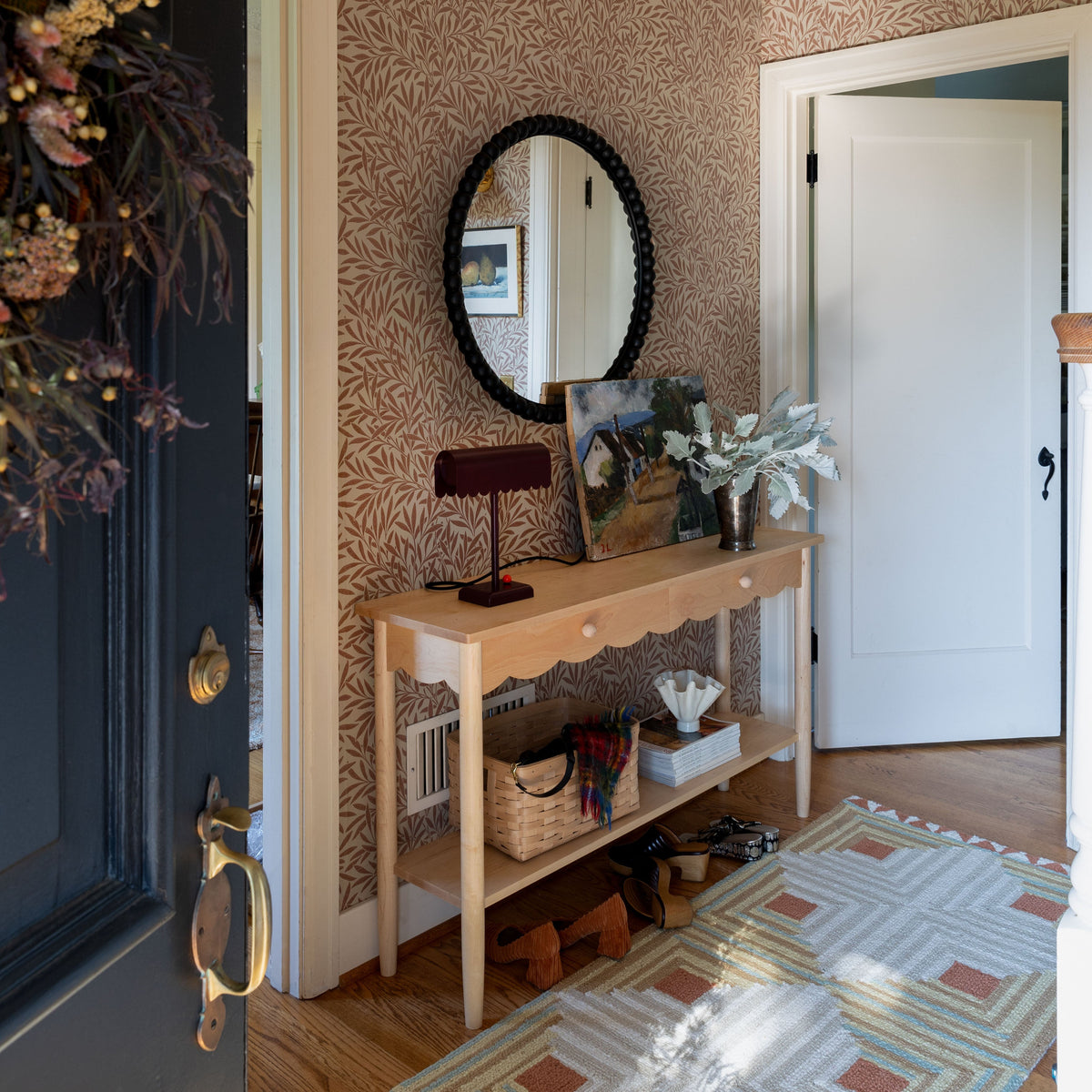Dolores Table Lamp displayed on a console table in a patterned-wallpaper entryway