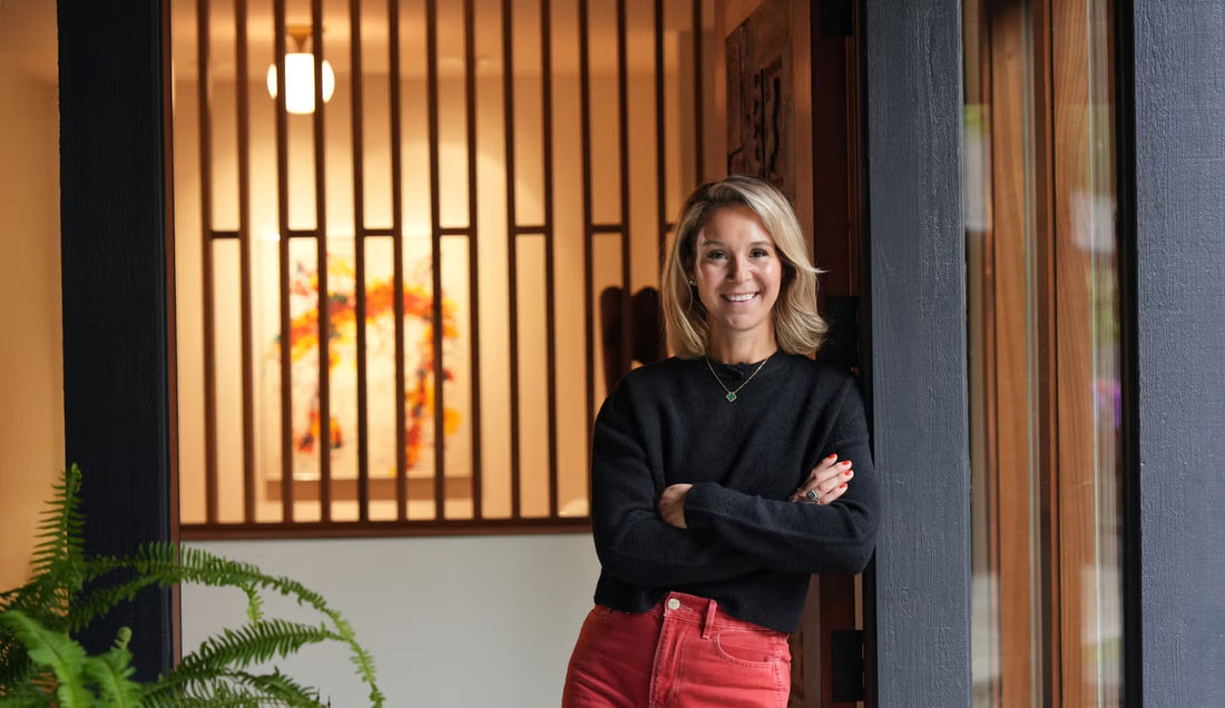 Smiling woman standing in the entryway of a nature-inspired midcentury Oregon home