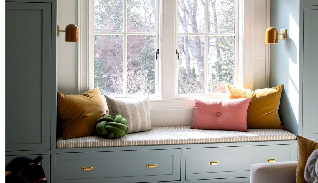 Blue built-ins with pillows on a bench.