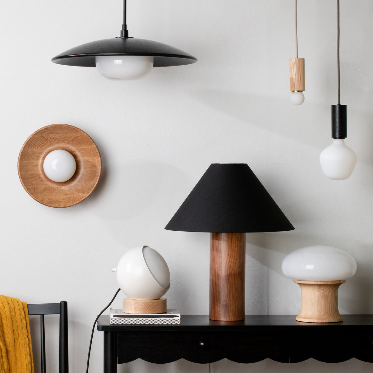 A variety of mixed material light fixtures and lamps.
