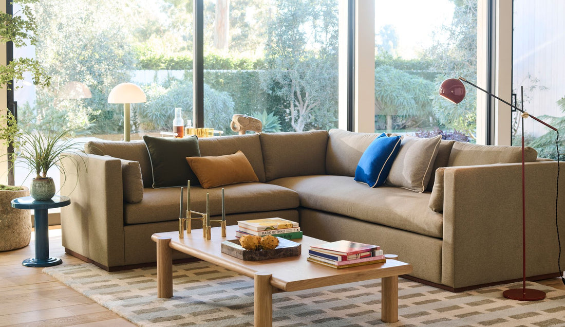 Bright living room with grey couch and colorful accent pillows