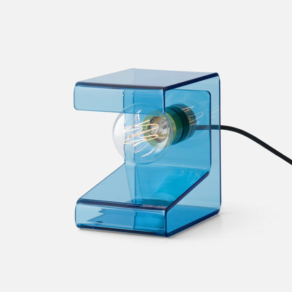 Close-up right-side view of Pop Light II table lamp showing blue translucent acrylic Z-shaped body and exposed filament bulb on white background
