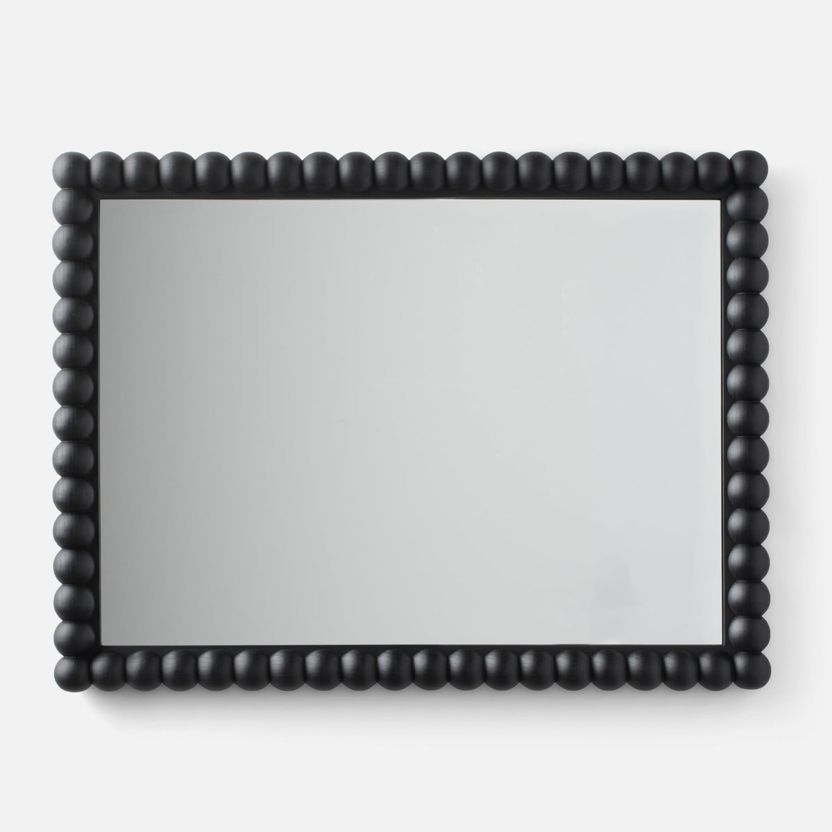 Close-up of Bobbin Mirror showcasing black beaded wooden frame on a white background