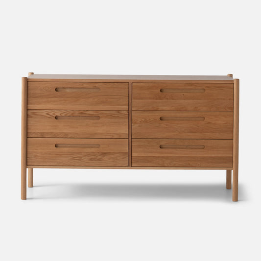 Front view of Nora 6-Drawer Dresser showcasing six drawers and pill-shaped handles against a light gray background
