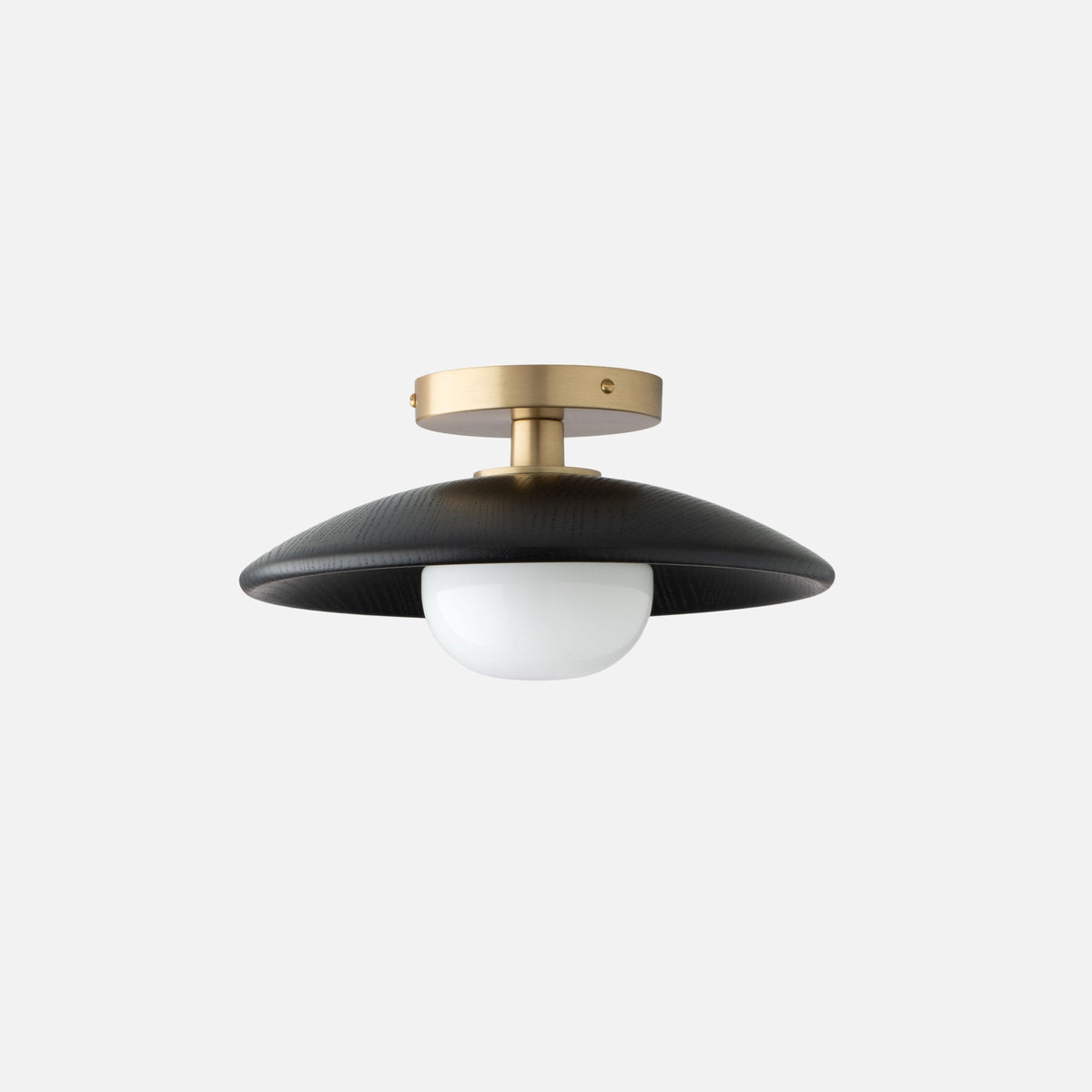 Front view of Atwood Flush Mount showcasing black oak shade, natural brass fixture, and opal glass with a light gray background
