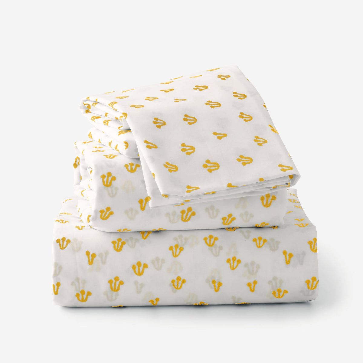 Folded view of Thistle Percale sheet set showcasing hand-drawn yellow thistle pattern with plain white background