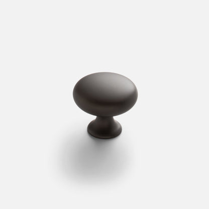 Front view of Somerset Knob showcasing its egg-shaped solid brass silhouette with a white background