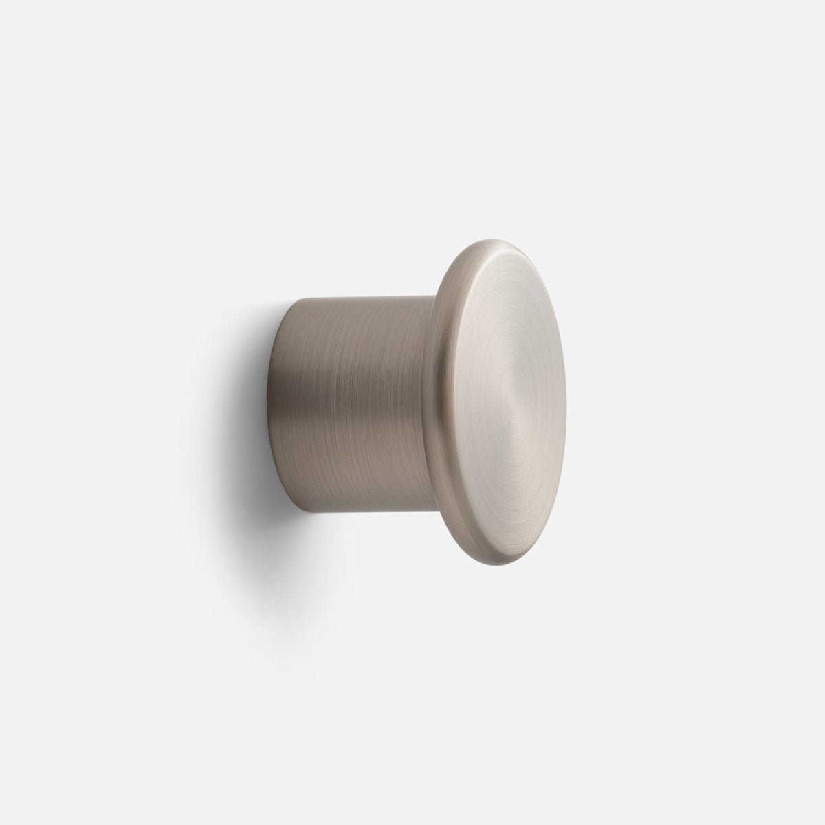 Close-up angled view of Remy Single Hook showcasing its cylindrical form with a plain light background