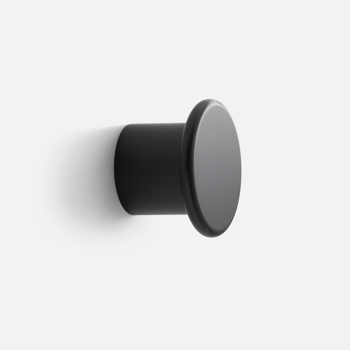 Close-up angled view of Remy Single Hook showcasing its black cylindrical form with a white background