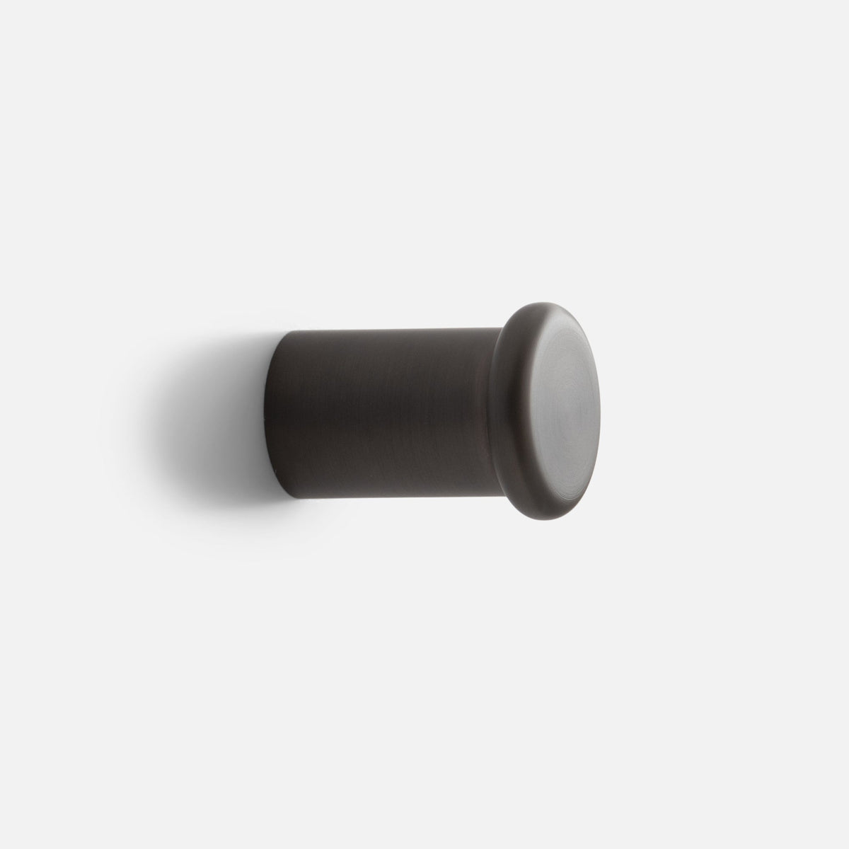 Side view of Remy Single Hook showcasing its cylindrical form and rounded end against a white background