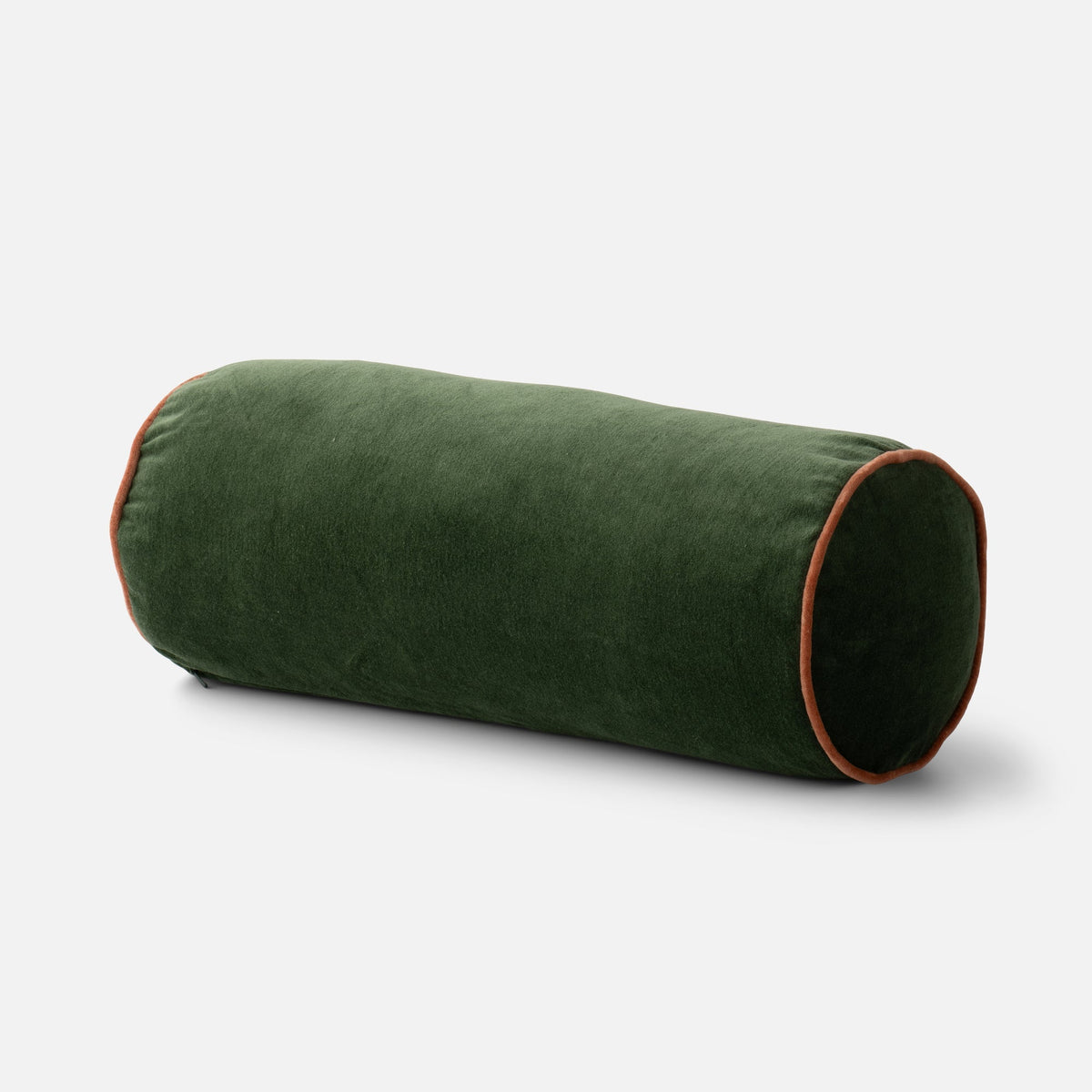 Three-quarter view of the Alder Green Velvet Piped Pillow showcasing soft cotton velvet and contrast piping on a light gray background