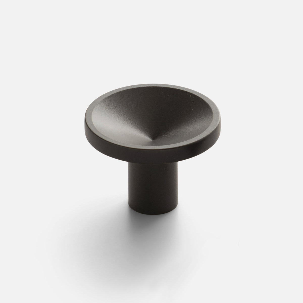 Close-up view of Rhone Cast Brass Knob showcasing its rounded textured top and cylindrical stem on a light background