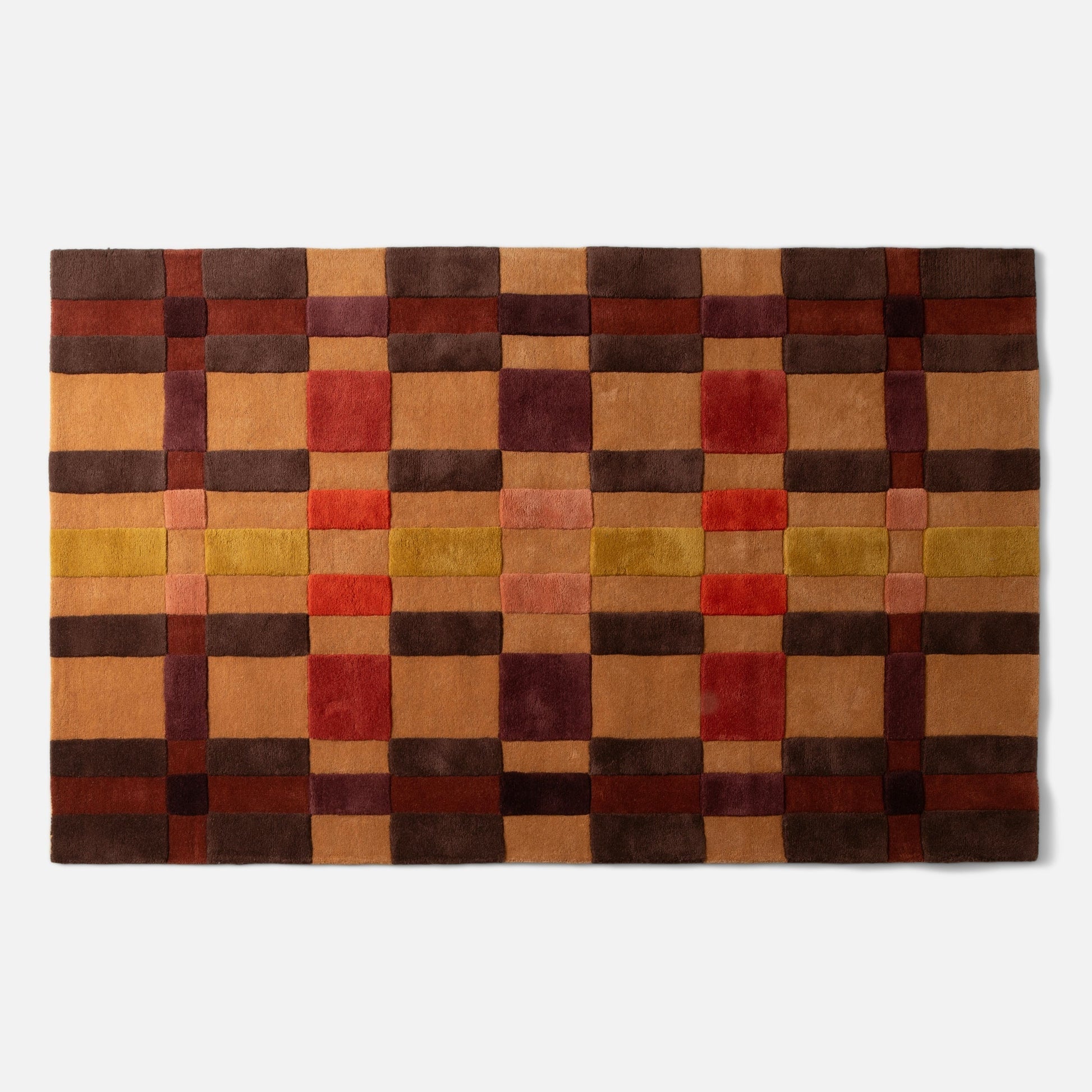 Top-down view of Campus Wool Rug showing recessed-pile plaid grid in brown, rust, mustard, and burgundy on white background