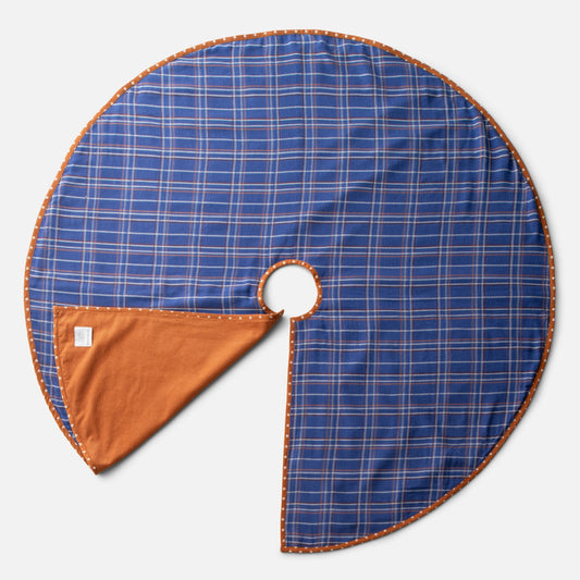 Top view of Haberdasher’s Tree Skirt showcasing cobalt blue plaid cotton and orange corduroy underside on a light gray background