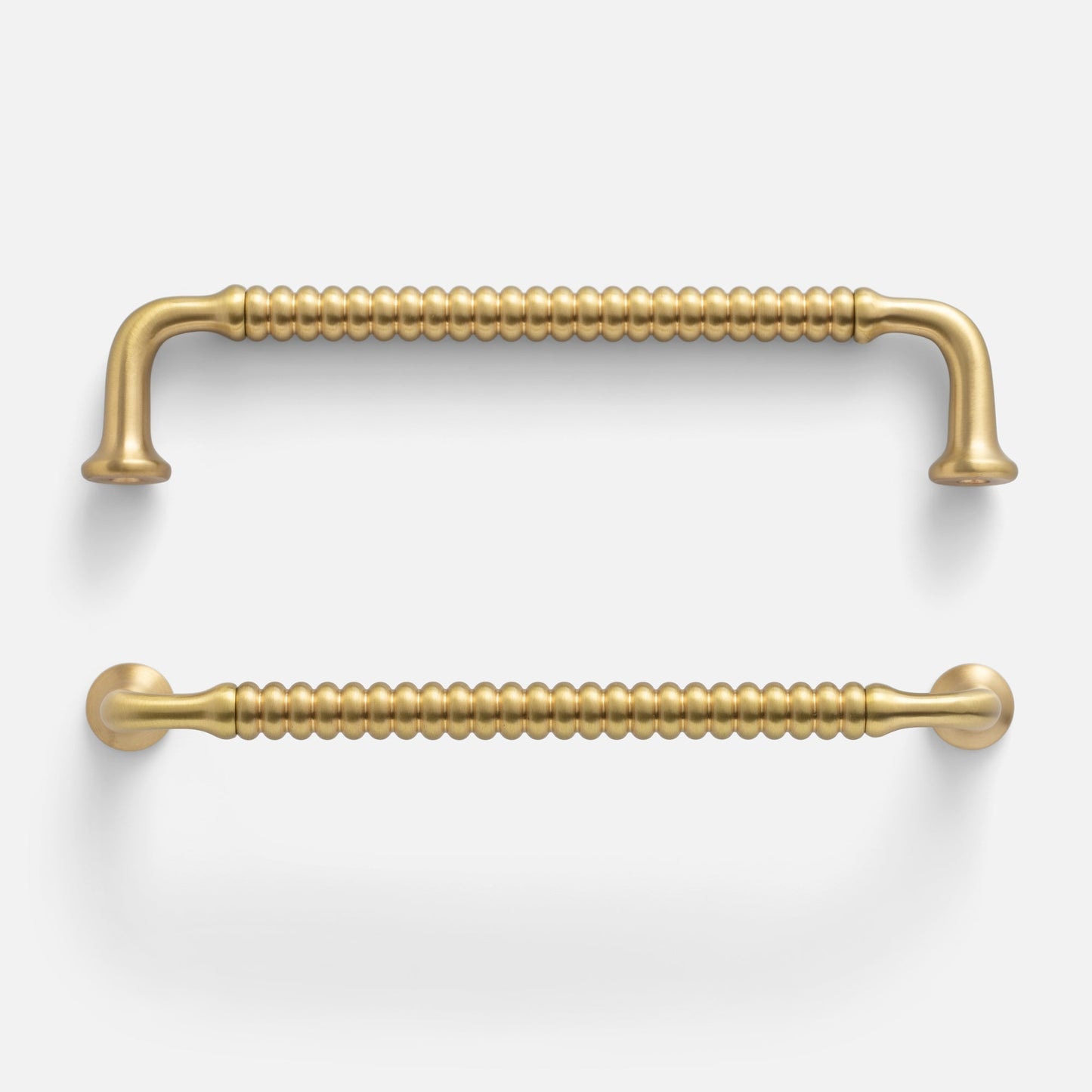 Front view of two Whittaker pulls showcasing beaded bar texture and satin brass finish on white background