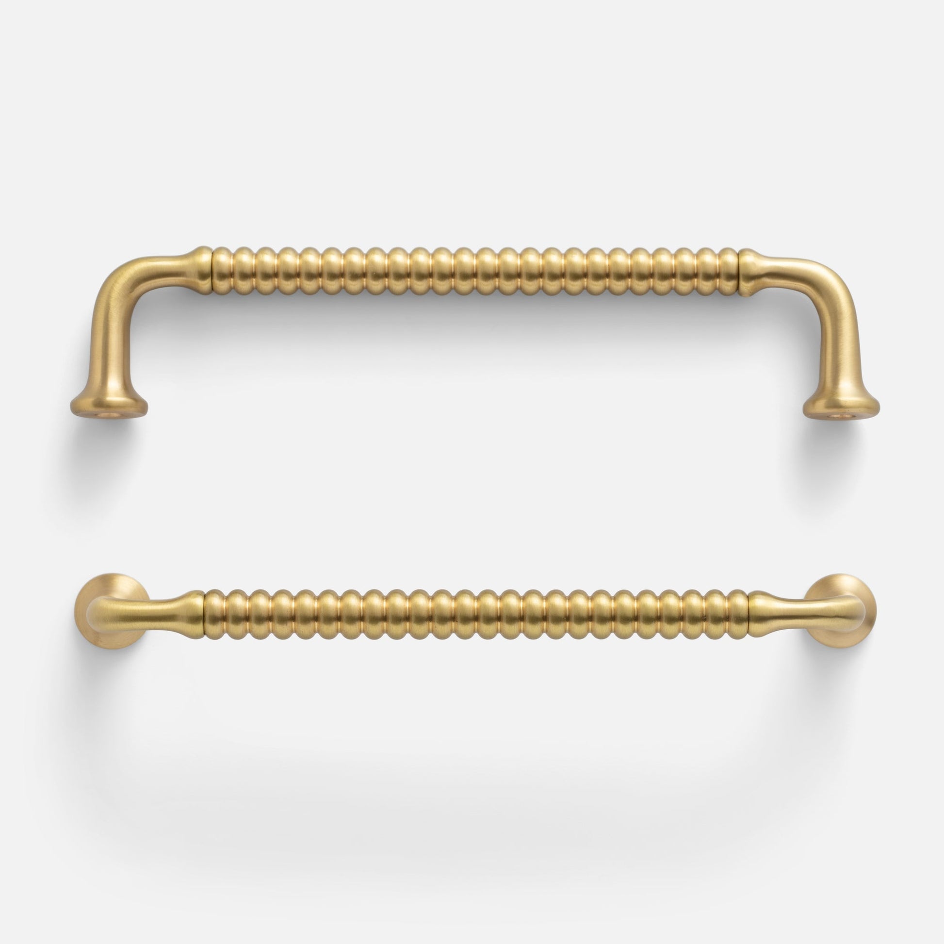 Front view of two Whittaker pulls showcasing beaded bar texture and satin brass finish on white background