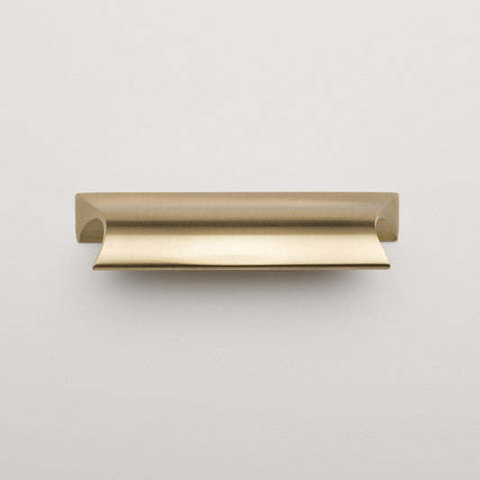 Front view of Card File Pull showcasing curved lip and brushed brass finish on light gray background