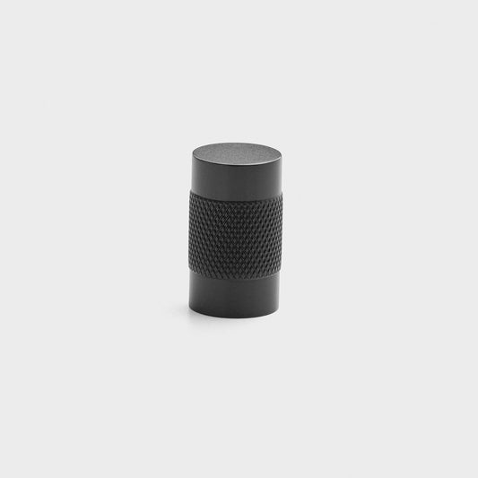 Front view of cylindrical knurled knob showing knurled midsection and matte black finish on light gray background