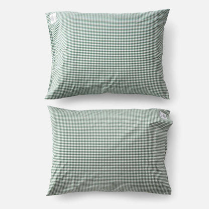 Top-down view of two Gingham Percale pillowcases (set of 2) showcasing juniper green gingham check pattern on white background