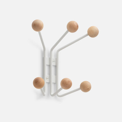 Angled front view of Mollie 6 Hook showcasing six white steel arms with natural oak ball knobs on light gray background