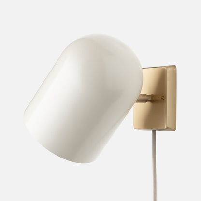 Angled close-up of Allegheny 6-inch Plug-In Sconce showing opal glass shade and satin brass backplate on white background